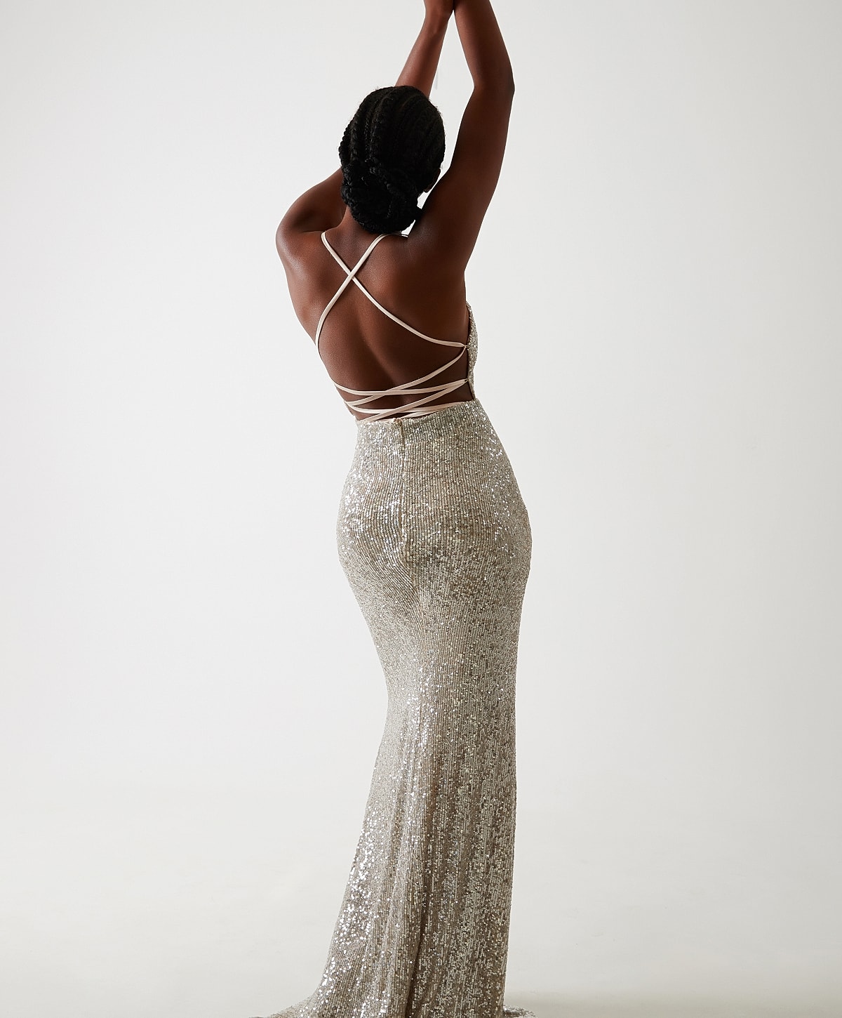 Model in sparkly silver evening gown, back view.