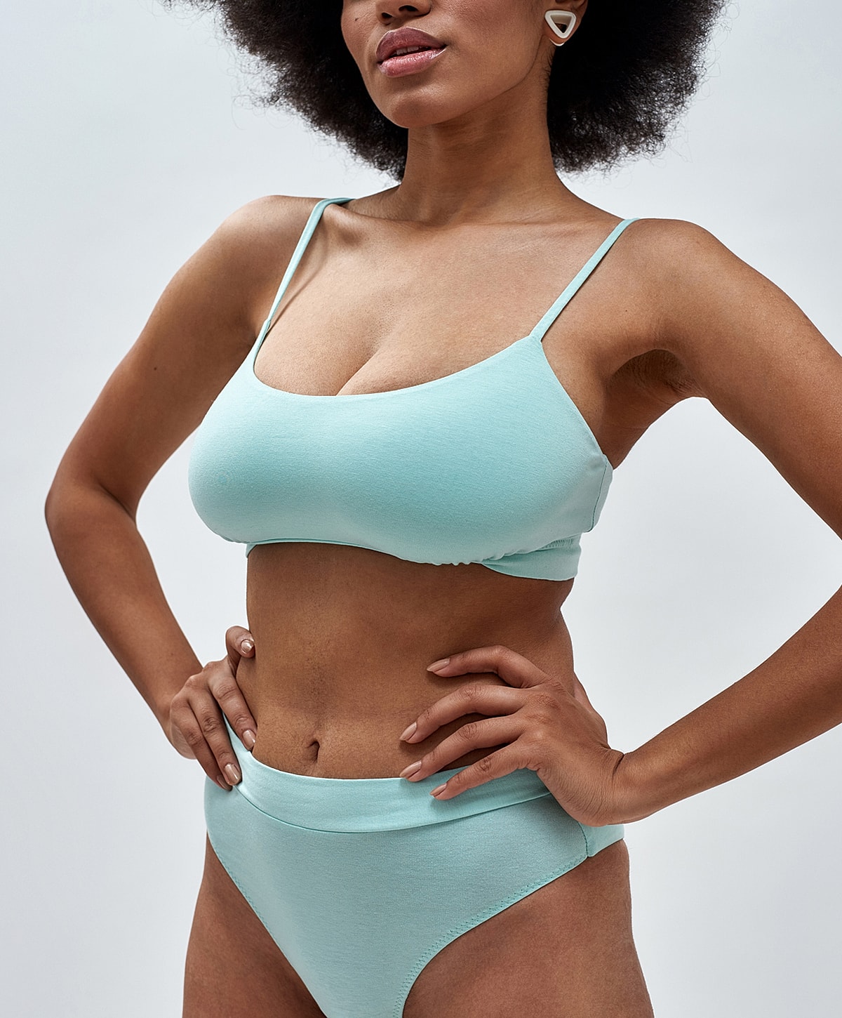 Model in mint green swimwear, stylish pose.