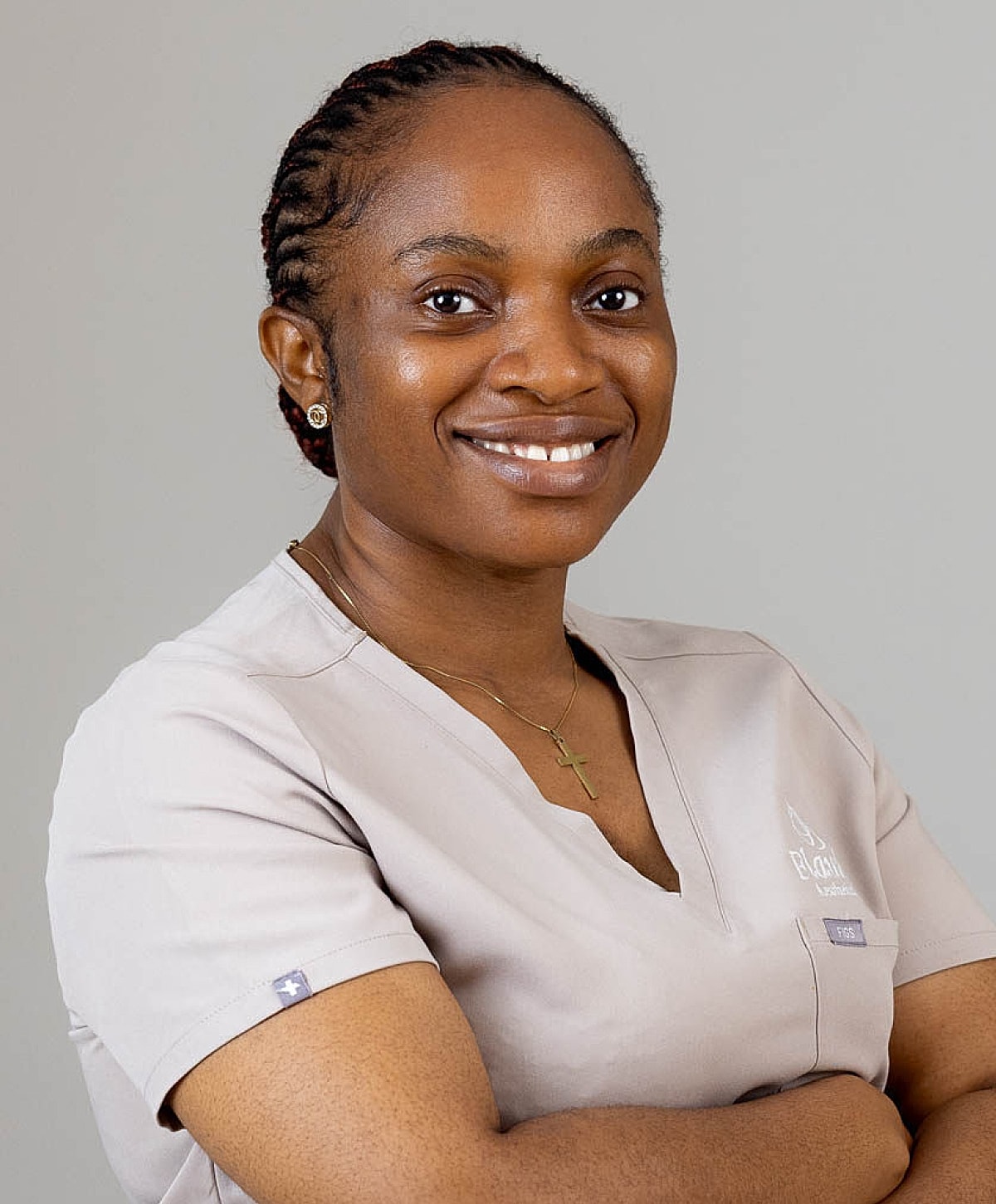 Smiling medical professional in scrubs.