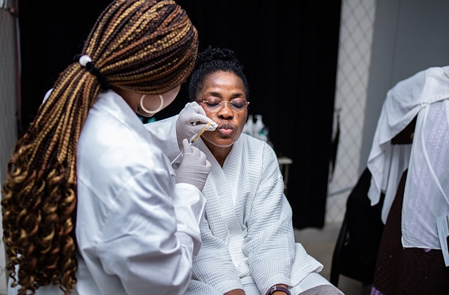 Client receiving facial treatment in professional setting.