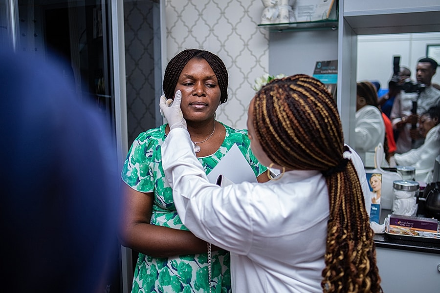 Client receiving facial consultation at beauty clinic.