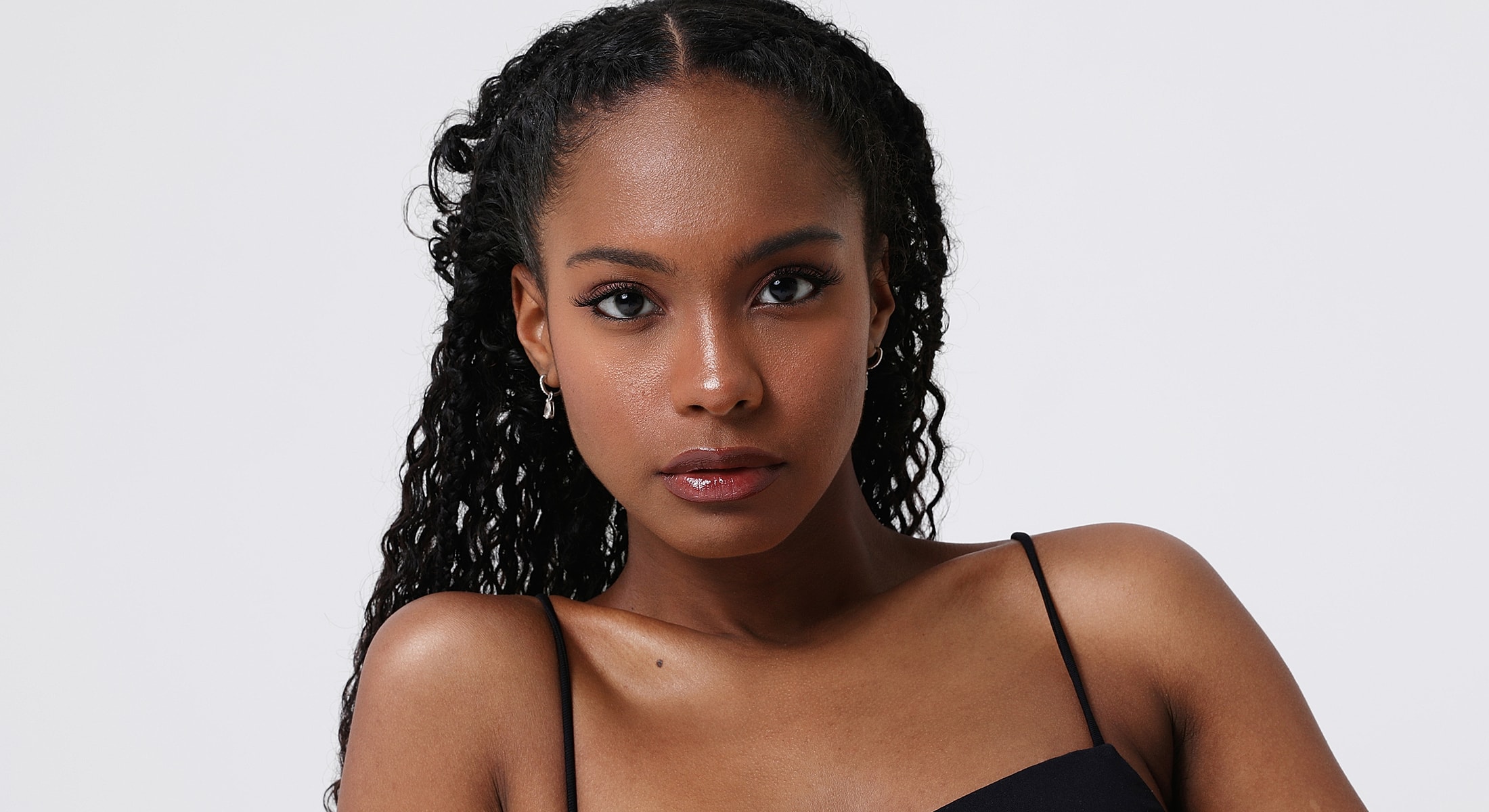 Portrait of a young woman with curly hair.