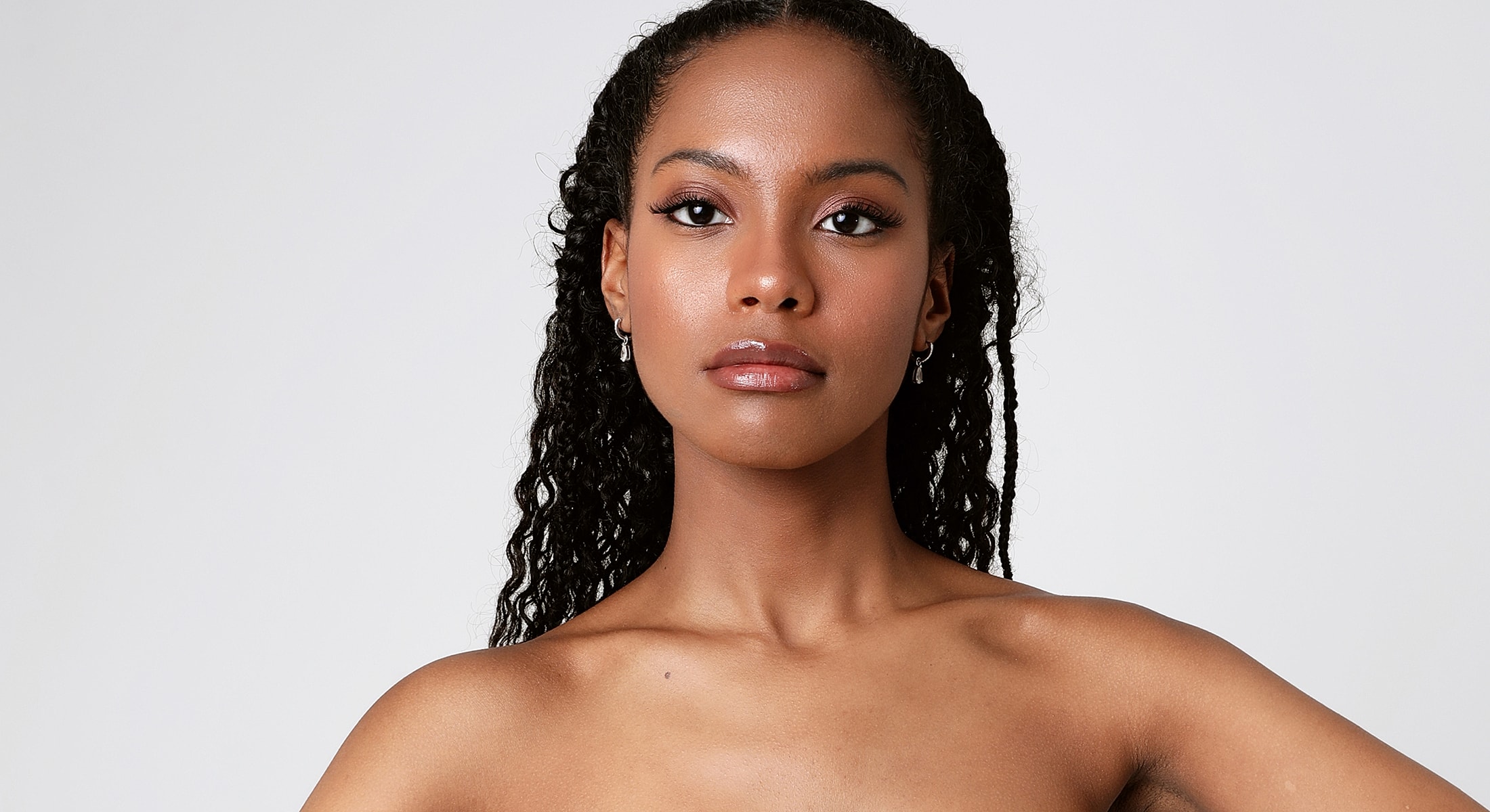 Portrait of a confident woman with curly hair.