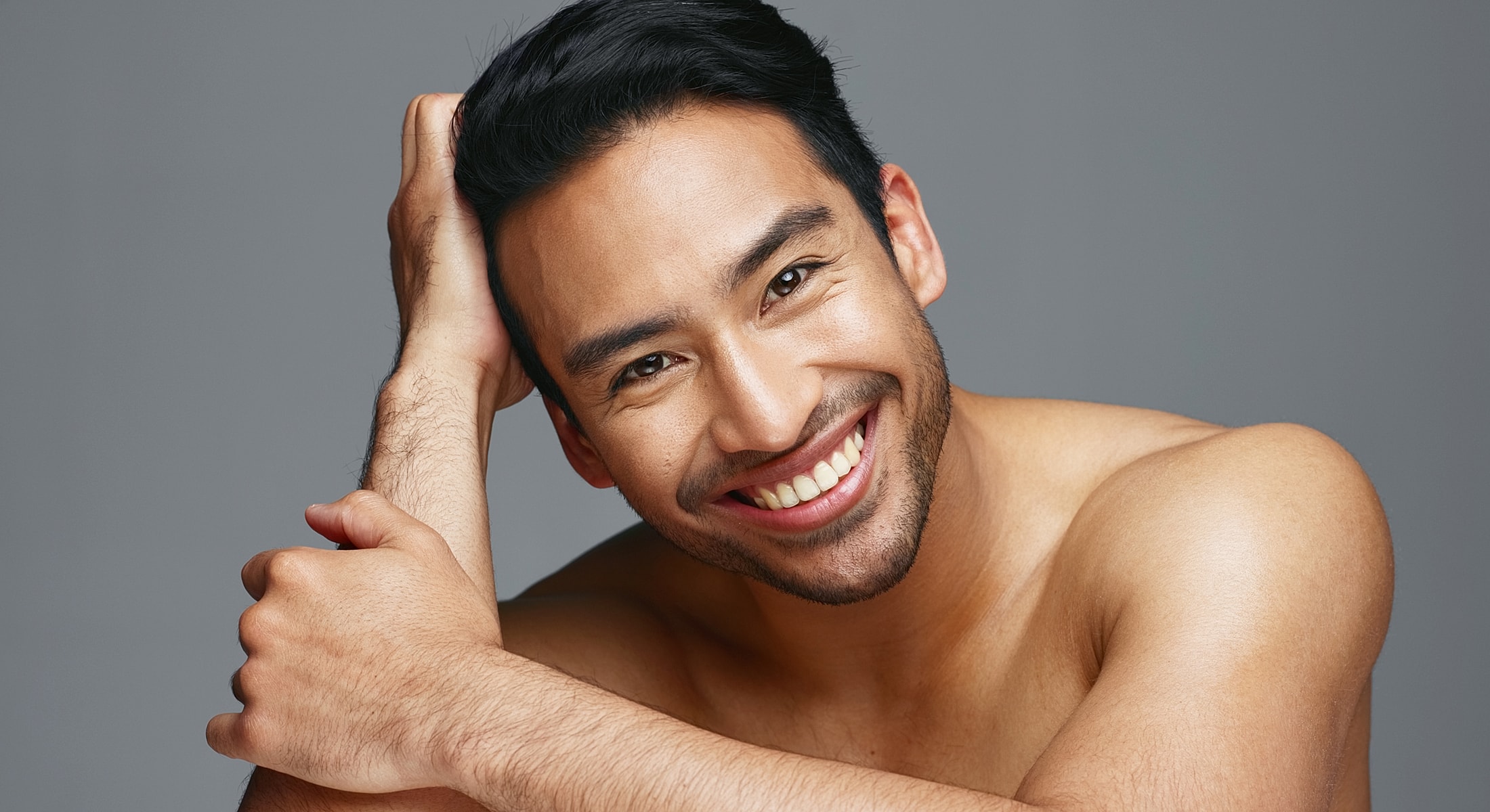 Smiling man with short hair in portrait.