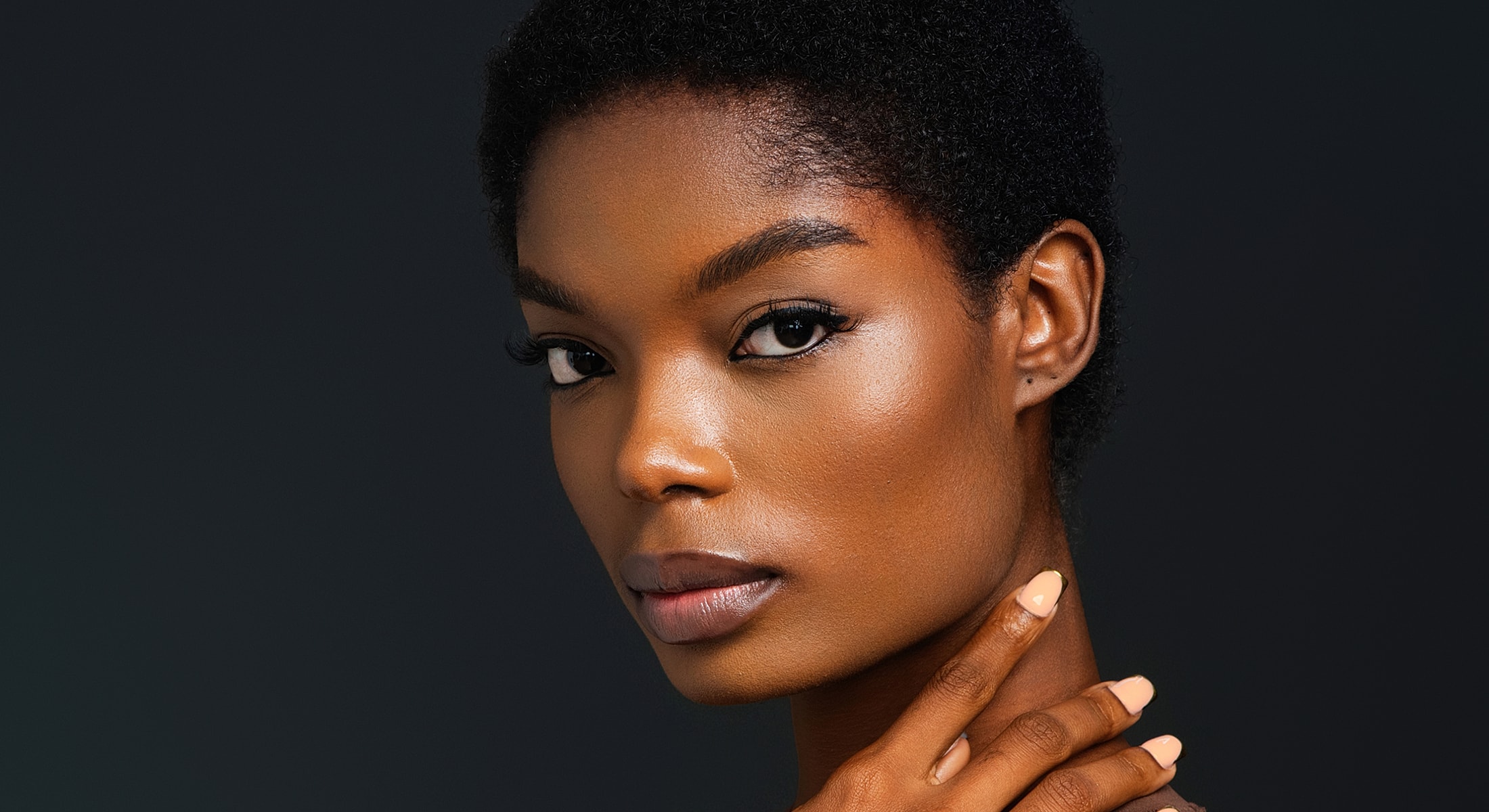 Portrait of a woman with short, natural hair.