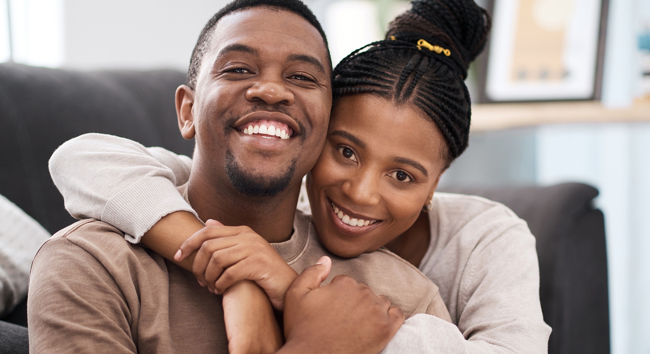 Happy couple embracing on a couch.