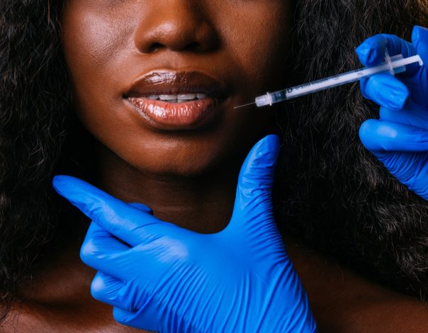 Ethnic woman getting Botox injectable in her lips