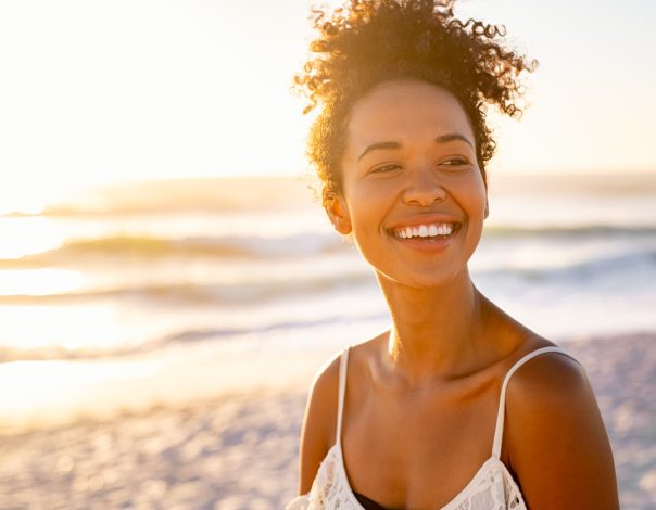 Young african woman at the beach