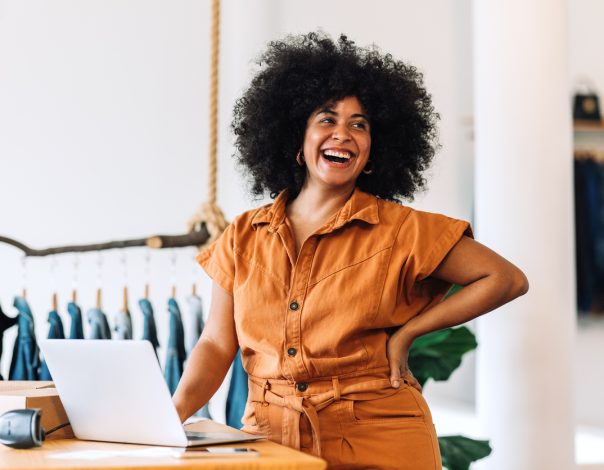 Young african woman smiling in her small business